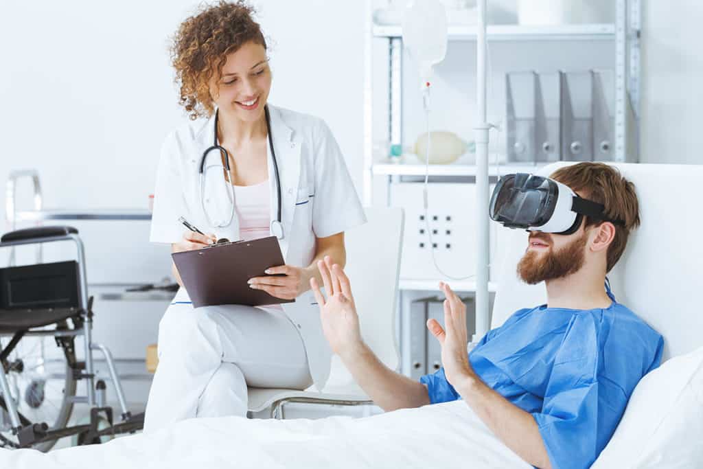 Young trauma patient wearing virtual reality glasses in hospital